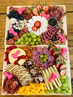 two trays filled with different types of food on top of a wooden table next to each other