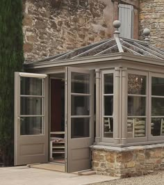 an orangery in front of a stone building