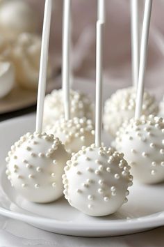 some white cake pops are on a plate