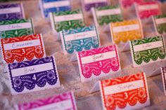 colorful place cards are on display for guests to write their names or numbers in them