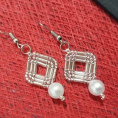 the earrings are made out of silver wire and pearls