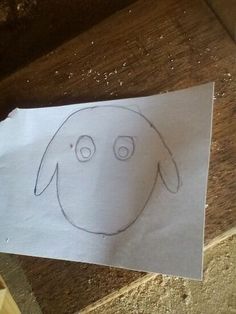 a piece of paper with a drawing of a dog's face drawn on it