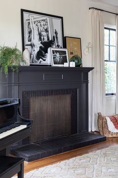 a living room with a piano and pictures on the wall