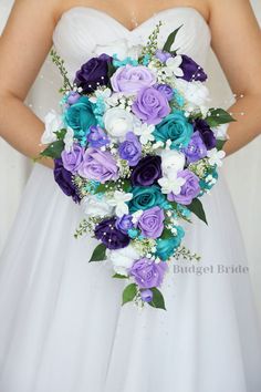 a bridal holding a purple and blue bouquet