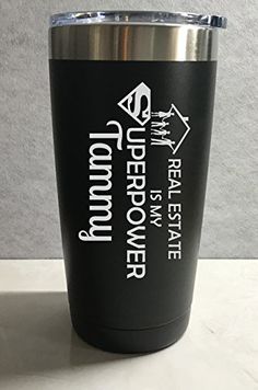 a black tumbler cup with white lettering on the side and an upside down logo