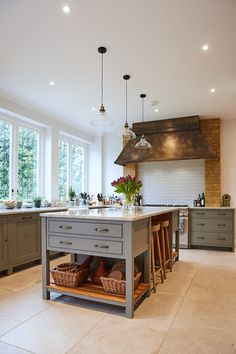 a large kitchen with an island in the middle