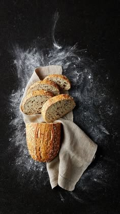 several loaves of bread sitting on top of a cloth