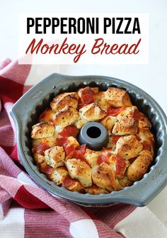 pepperoni pizza monkey bread in a pan on a red and white checkered table cloth