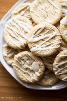 a white plate topped with cookies covered in icing