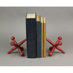 two books are sitting next to each other on the same bookends, one is red and the other is black