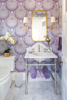 a white sink sitting under a mirror in a bathroom