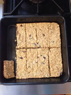 some oatmeal squares in a pan on top of a stove burner