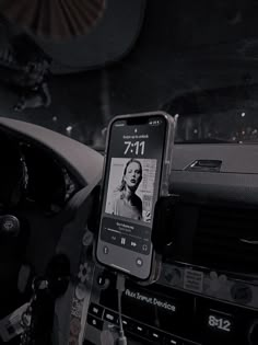 a cell phone is hooked up to the dashboard of a car with an mp3 player attached