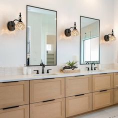 a large bathroom with double sinks and mirrors