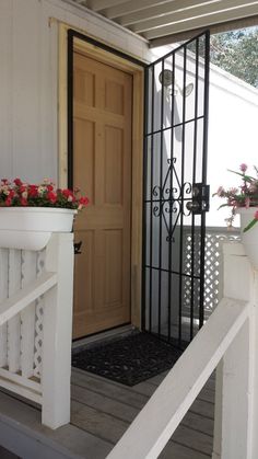 the front door is open and there are flowers on the steps