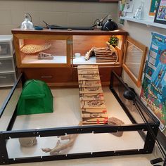 a display case filled with lots of boxes and papers on top of a white floor