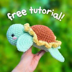 a hand holding a crocheted turtle with the words free pattern on it's back