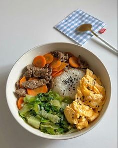 a bowl filled with rice, meat and vegetables