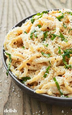 a bowl filled with pasta and parmesan cheese