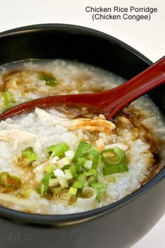 a bowl of chicken rice soup with chopsticks and green onion garnish