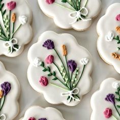 some decorated cookies with flowers on them