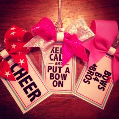 three cheer tags with bows hanging from them