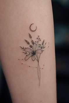 a tattoo with flowers and a crescent on the back of her arm, is shown