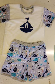 This is a listing for a 2 piece short and T shirt style top made with fleece. The shorts will have snaps in the crotch/inner legs, and be made with the full print. The top will be white fleece with the print for the sleeves, and a picture on the front/center (of the ship, or whale, or whichever of the pictures you'd prefer to match the fabric). Please include the following measurements in inches: chest hips top of thigh (basically all the way around the top of one leg) neck shoulder to crotch sh Diaper Shirt, Shirt Style Tops, Footie Pajama, White Fleece, T Shirt Style, Shorts Set, Shirts & Tops, Short Sets, Short Sleeve Shirt