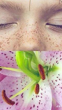 a woman's eyes are open and there is a pink flower in front of her