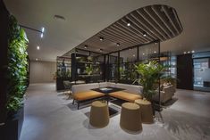 a living room filled with lots of furniture and plants