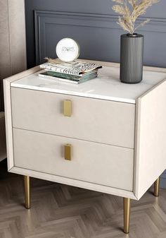 a nightstand with two drawers and a vase on top