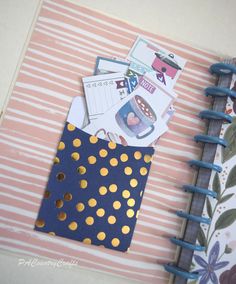 an open notebook with gold polka dots on it and a blue dotted pocket for notepads