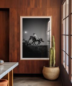 a horse running on the track is framed in wood