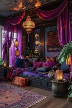 a bedroom with purple curtains and lots of pillows on the bed, lights hanging from the ceiling