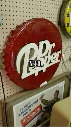 there is a red sign that says dr pepper on the wall next to other clocks