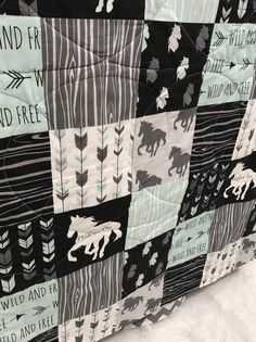 a black and white quilt with horses on it