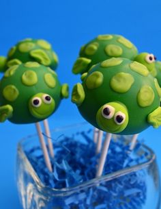 some green cake pops with googly eyes on them