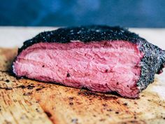 a piece of meat sitting on top of a wooden cutting board