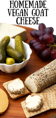 homemade vegan goat cheese with crackers, grapes and cucumbers on a cutting board