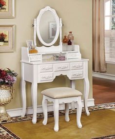 a white dressing table with a mirror and stool