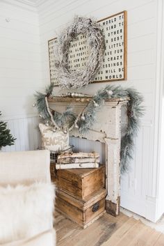 a living room decorated for christmas with wreaths on the mantle