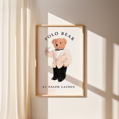 a bear in a tuxedo is hanging on the wall next to a window