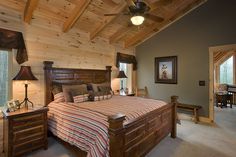 a bedroom with a bed, dresser and ceiling fan in it's center area