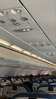 the inside of an airplane with rows of seats