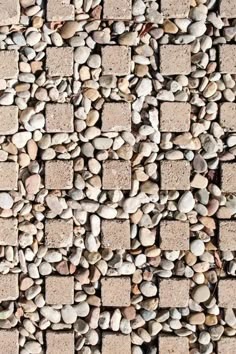 a close up view of some rocks and cement bricks on the ground, as if it were made out of small stones