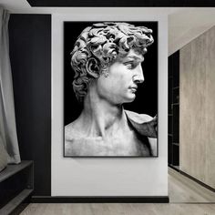 a black and white photo of a bust of a man with curly hair on the wall