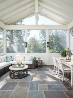 a living room filled with furniture and lots of windows