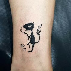 a small tattoo on the foot of a person with a lizard and words do it