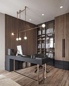 an office with a desk, bookshelf and shelves filled with books on it