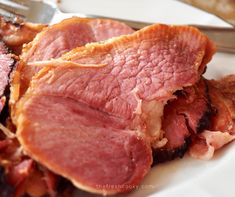 the ham is cut up and ready to be eaten with a fork on the plate